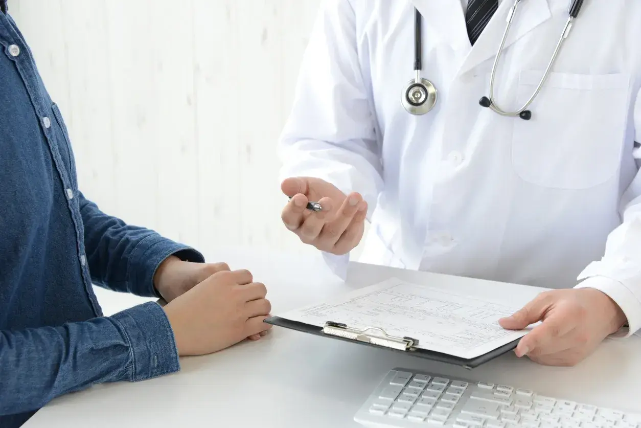 A doctor reviewing medical results with a patient using a digital device for better healthcare insights.
